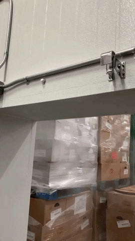 A small clip of a freezer door closing using an auto door closer